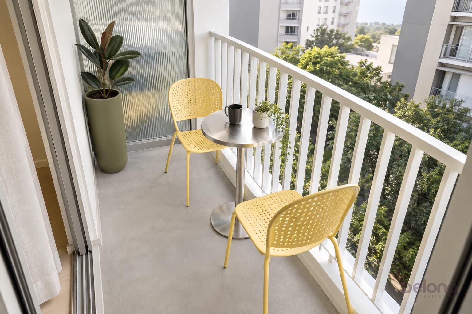 Tiny modern balcony with yellow metal café chairs, a steel pedestal table and fluted-glass privacy screen.