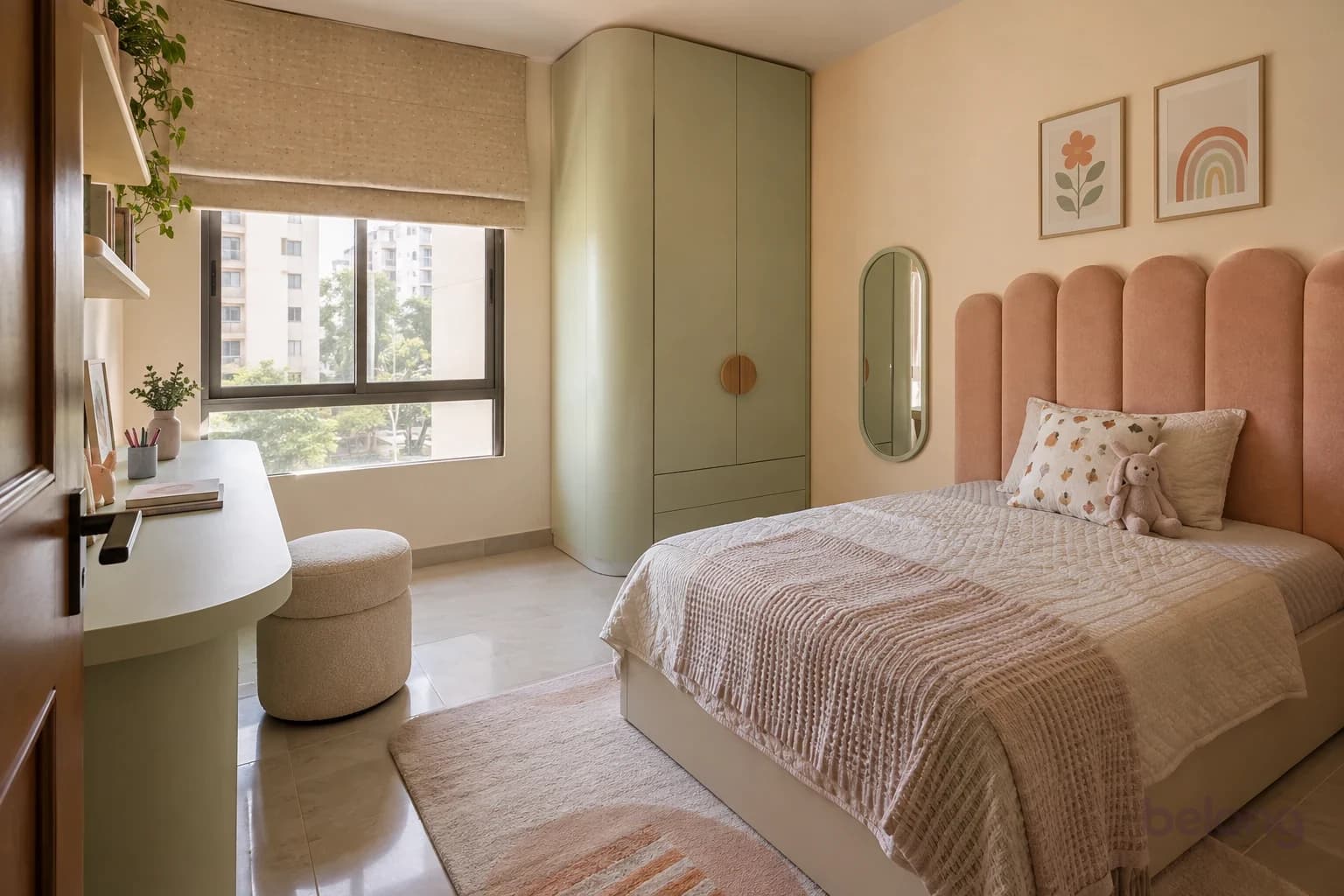 A compact child's bedroom with a peach scalloped headboard, oatmeal quilt, rounded wardrobe, pale mint study desk, rounded stool and pill-shaped wall mirror.