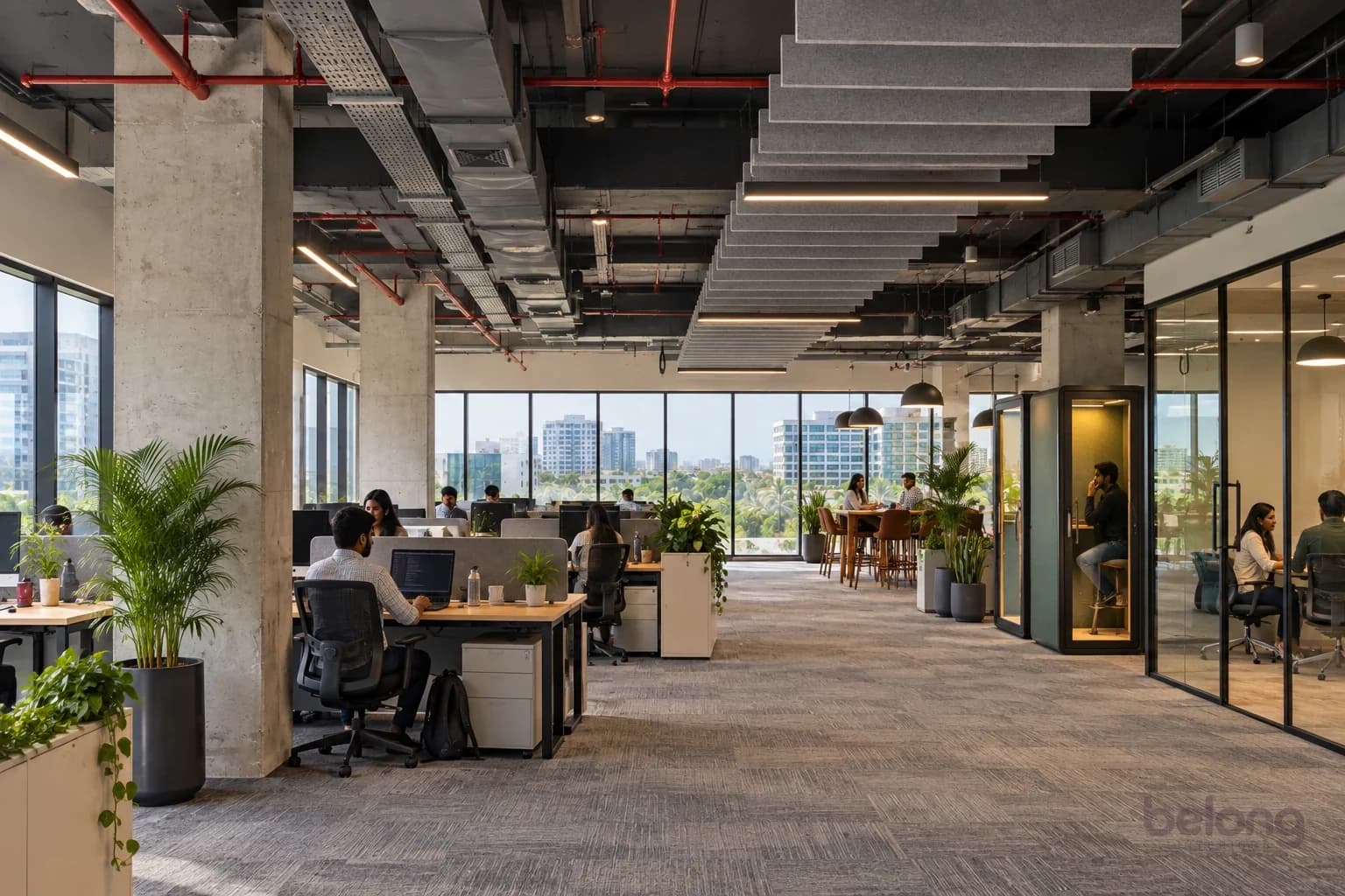 The same floor after fit-out: desk clusters by the windows, felt baffles, glass meeting rooms, phone booths, plants and carpet tiles.
