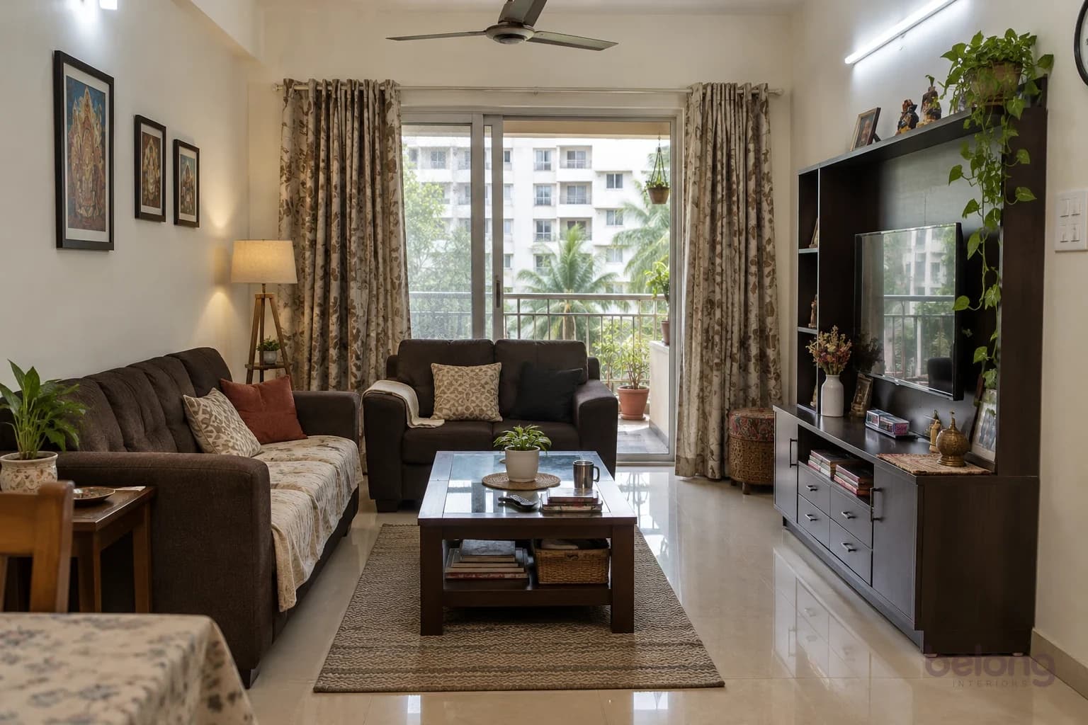An ordinary apartment living room before: beige floor tiles, a dark sofa set, heavy curtains, a single bright tube light and a crowded TV unit.