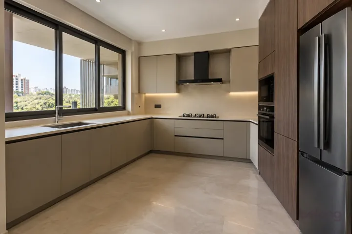 New modern compact L-shaped kitchen in greige and dark oak, with cream porcelain slab worktops and pale beige large-format ceramic.