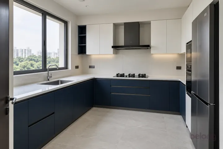 New modern compact L-shaped kitchen in ink blue and cloud white, with white quartz with sparse subtle grey veins worktops and large matte off-white ceramic rectangles.