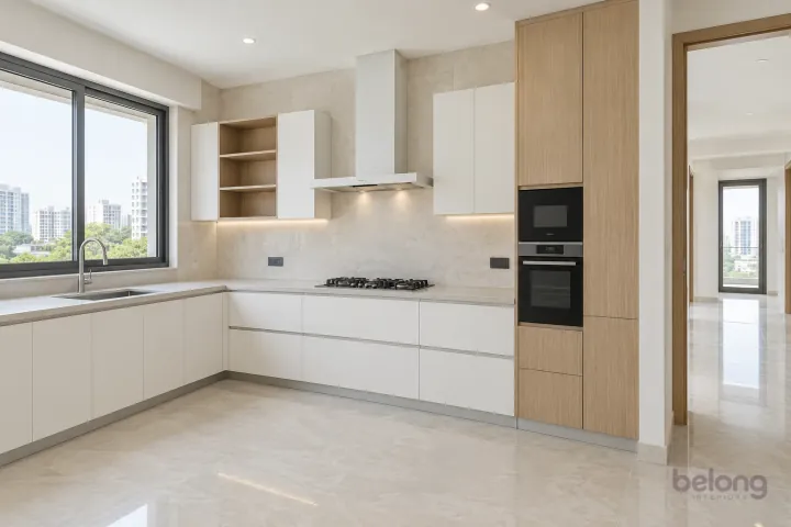 White L-shape opening to a clear plan, with pure white and pale grey quartz finishes, precise fitted joinery and pristine surfaces in a contemporary Indian home.