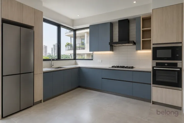 New modern compact L-shaped kitchen in denim blue and pale ash, with pale grey quartz worktops and ivory narrow rectangular tiles in horizontal stack.