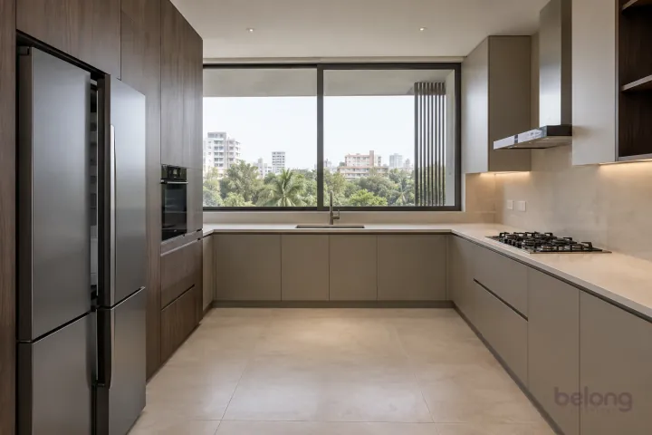 New modern generous U-shaped kitchen in greige and dark oak, with cream porcelain slab worktops and pale beige large-format ceramic.