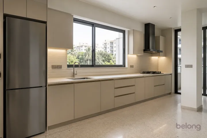 New modern compact straight kitchen in oatmeal and brushed bronze, with warm ivory sintered stone worktops and slim horizontal oatmeal ceramic tiles.
