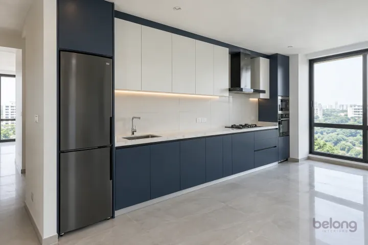 New modern compact straight kitchen in ink blue and cloud white, with white quartz with sparse subtle grey veins worktops and large matte off-white ceramic rectangles.