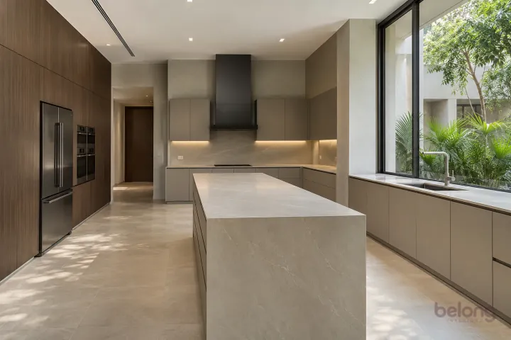 Contemporary villa kitchen with taupe cabinetry, a dark oak island and large shaded courtyard glazing.