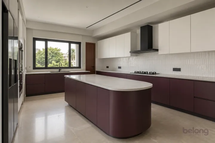 New modern villa kitchen with a central island in aubergine and porcelain white, with white fine-veined porcelain worktops and white vertical stacked tiles.