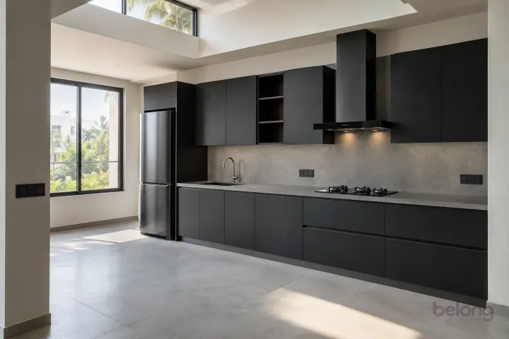 New modern compact straight kitchen in matte black and slate, with honed grey porcelain worktops and pale concrete-look slab backsplash.