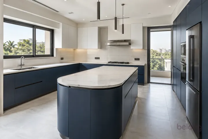 New modern villa kitchen with a central island in ink blue and cloud white, with white quartz with sparse subtle grey veins worktops and large matte off-white ceramic rectangles.