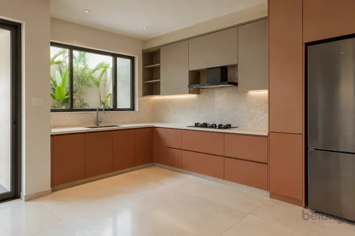 New modern compact L-shaped kitchen in terracotta and warm taupe, with cream solid surface worktops and very pale beige fine-speckle terrazzo backsplash.