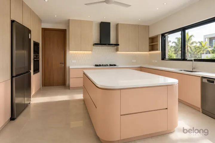 New modern villa kitchen with a central island in peach and bleached oak, with warm-white quartz worktops and ivory elongated hexagonal porcelain tiles.