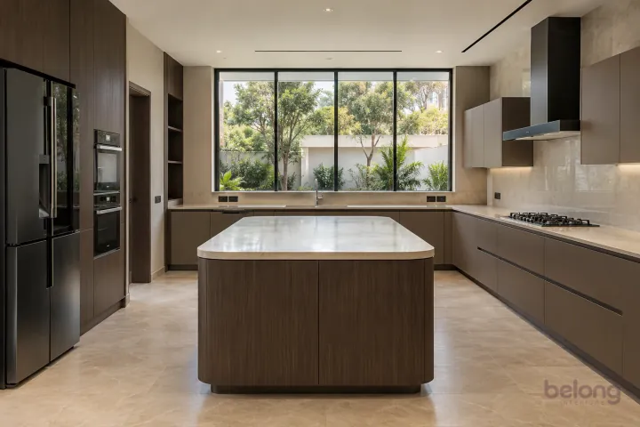 New modern villa kitchen with a central island in espresso and mocha, with cream quartzite-look porcelain worktops and warm off-white large slab backsplash.