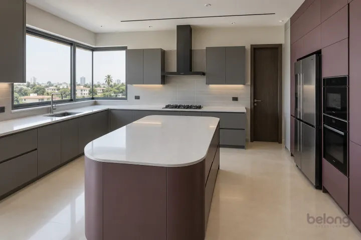 New modern villa kitchen with a central island in storm grey and muted plum, with white quartz worktops and pale grey rectangular ceramic tiles with slim grout.