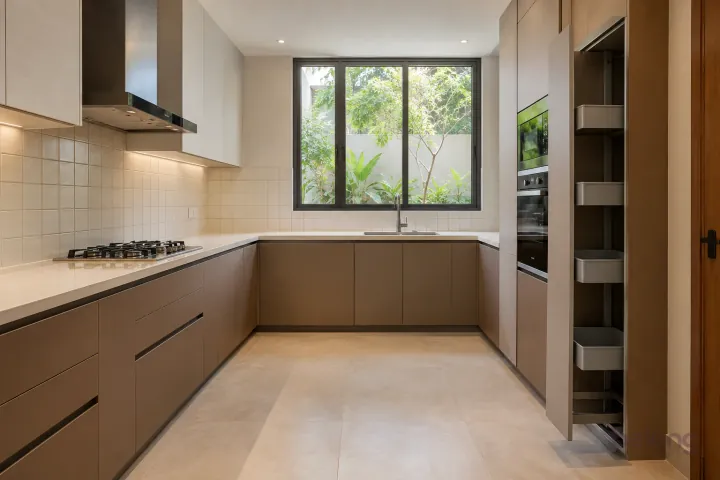 New modern slim pull-out pantry in cocoa brown and linen, with ivory quartz worktops and warm-white square tiles with matching grout.