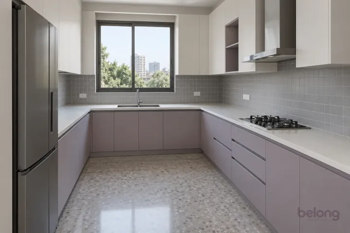 New modern generous U-shaped kitchen in lilac grey and warm white, with plain white quartz worktops and soft grey satin square tiles.