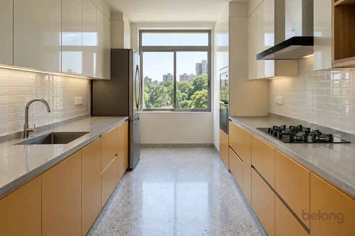 New modern parallel kitchen with a clear aisle in muted saffron and off-white, with pale grey quartz worktops and off-white small rectangular ceramic tiles.